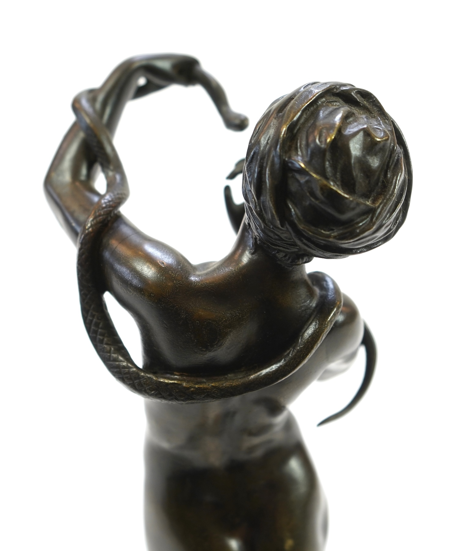 Josef Wind (German, 1864-1889). A patinated bronze of a nude female snake charmer